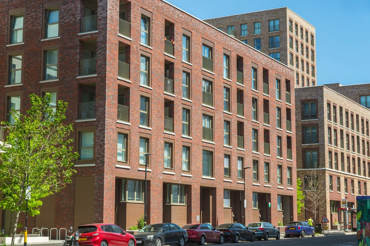 A new brick street frontage with balconies on the residential floors above ground-level units.