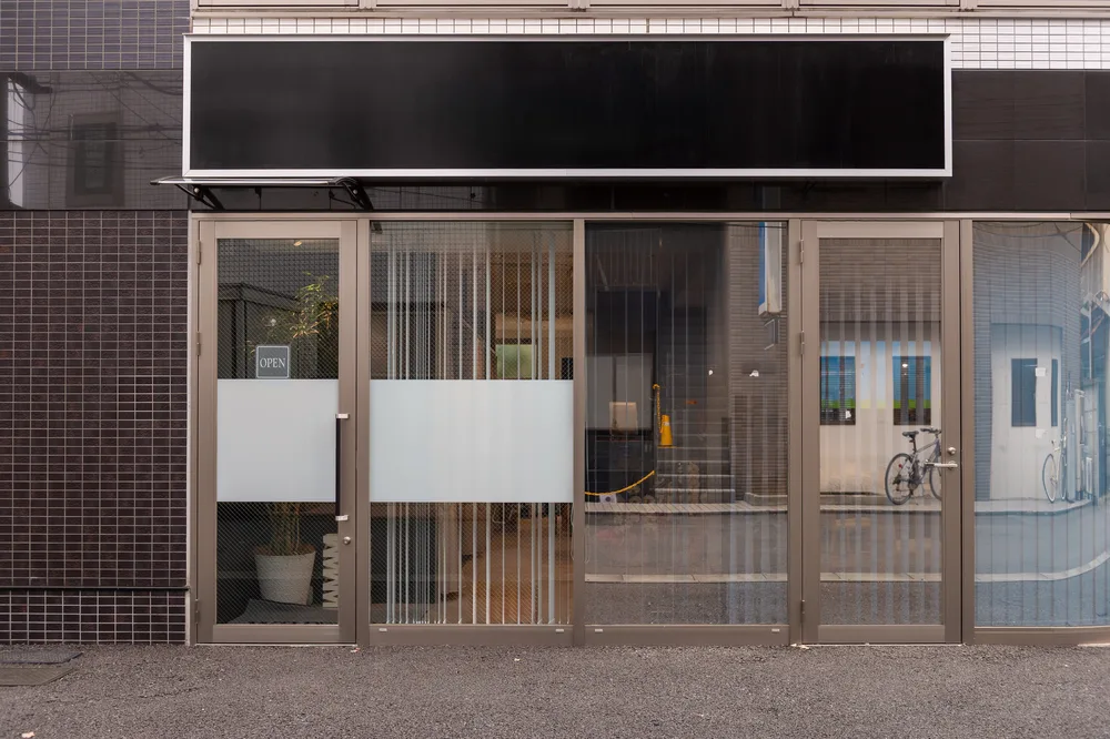 A small glazed storefront with an aluminum frame and a blank signage panel above.