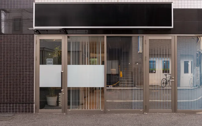 A small glazed storefront with an aluminum frame and a blank signage panel above.